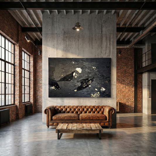 Modern industrial living room with leather sofa, coffee table, and abstract wall art.