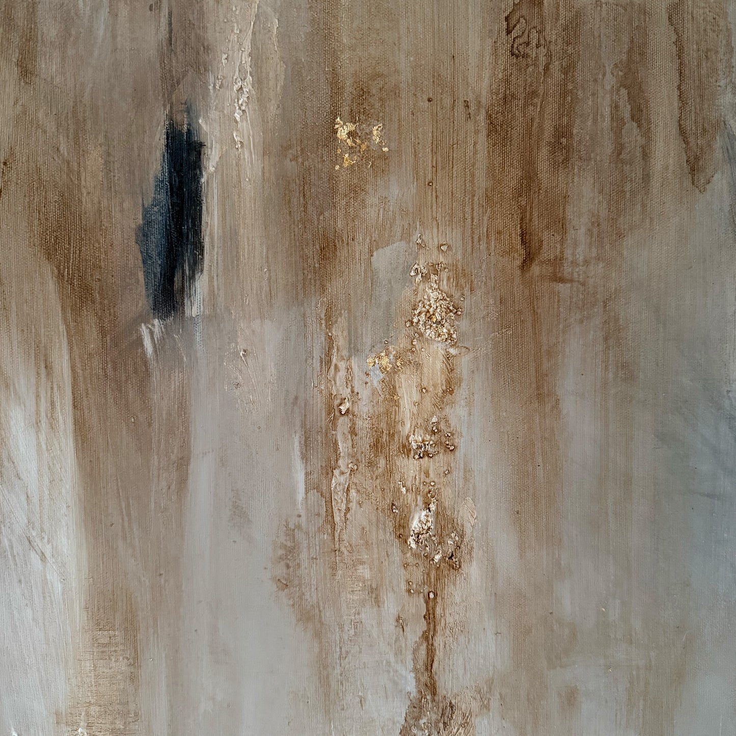 Abstract art with brown, black, and gold colors on a textured surface