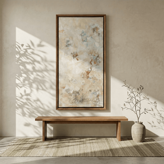 Wooden bench in a room with a large abstract painting on the wall and a plant on the floor.