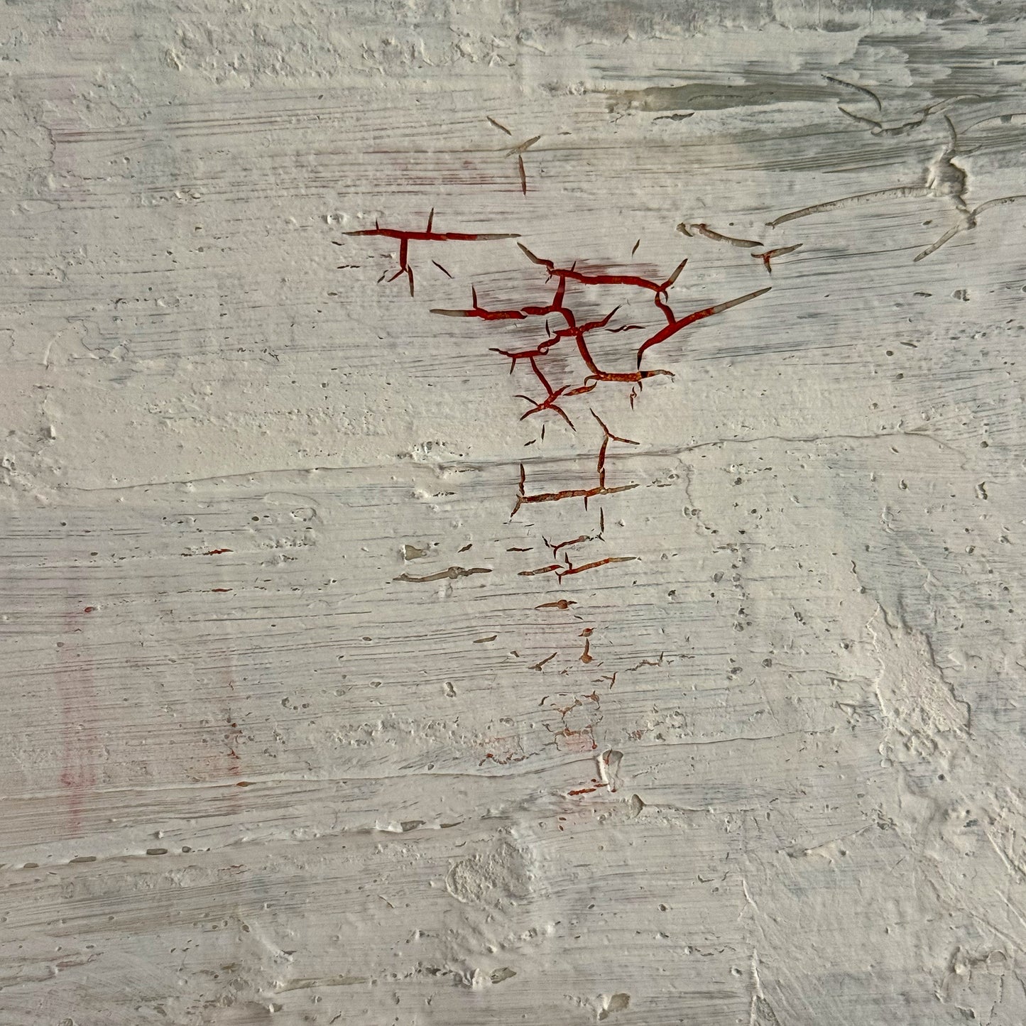 Red abstract pattern on a textured gray background