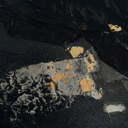 Textured fabric with gold and silver patterns on a black background