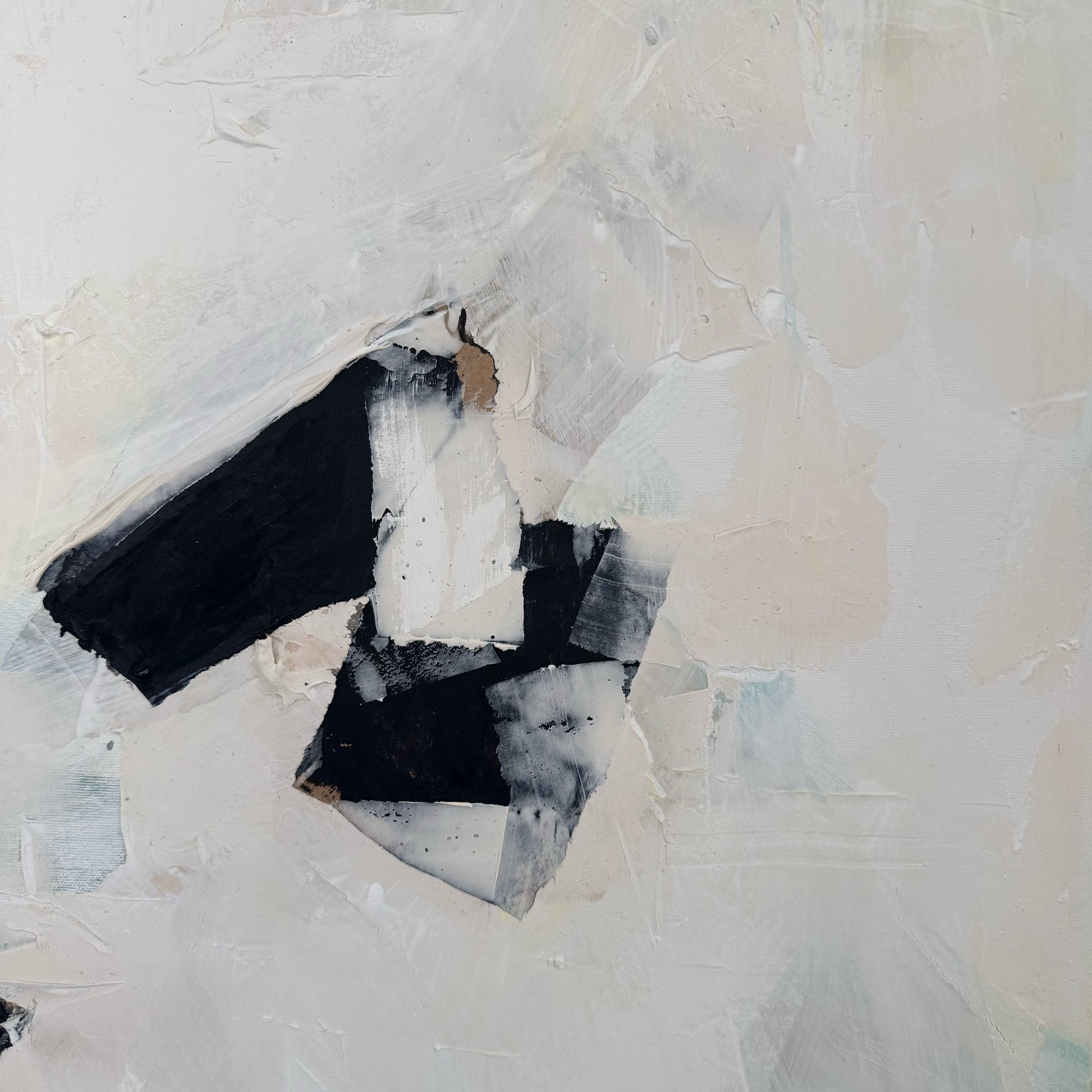Abstract art piece with black and white shapes on a textured beige background