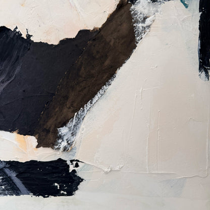 Abstract art piece with black, white, and beige colors on a textured surface
