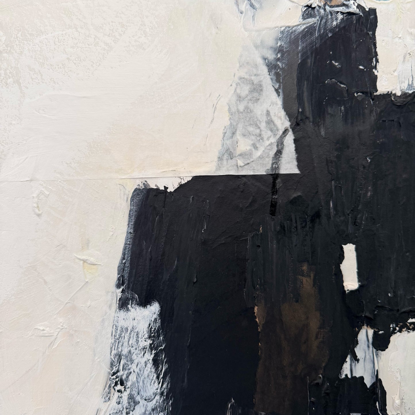 Abstract art with black and white brush strokes on a textured surface
