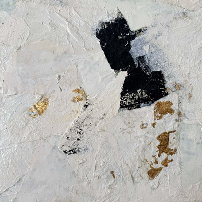 Abstract art piece with black and gold elements on a textured white background