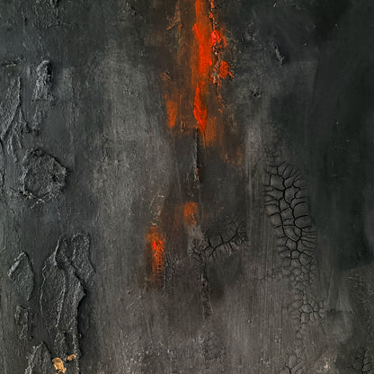 Close-up of textured dark surface with red-orange streaks