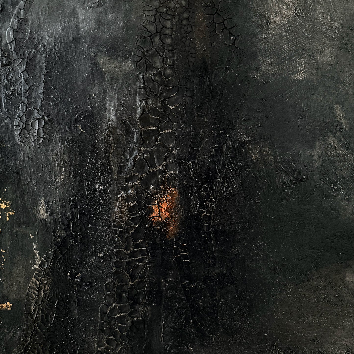 Close-up of a textured dark surface with a central glowing area