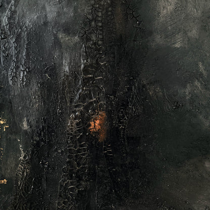 Close-up of a textured dark surface with a central glowing area