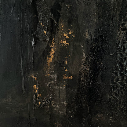 Textured black surface with gold accents