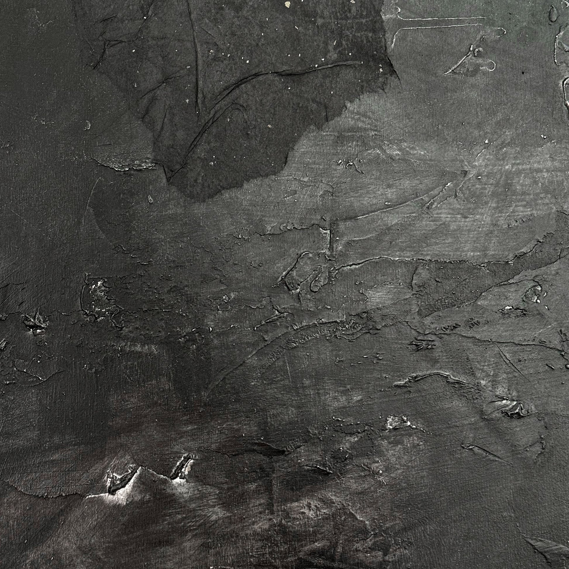 Textured black and gray surface with abstract patterns