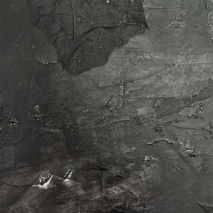 Textured black and gray surface with abstract patterns