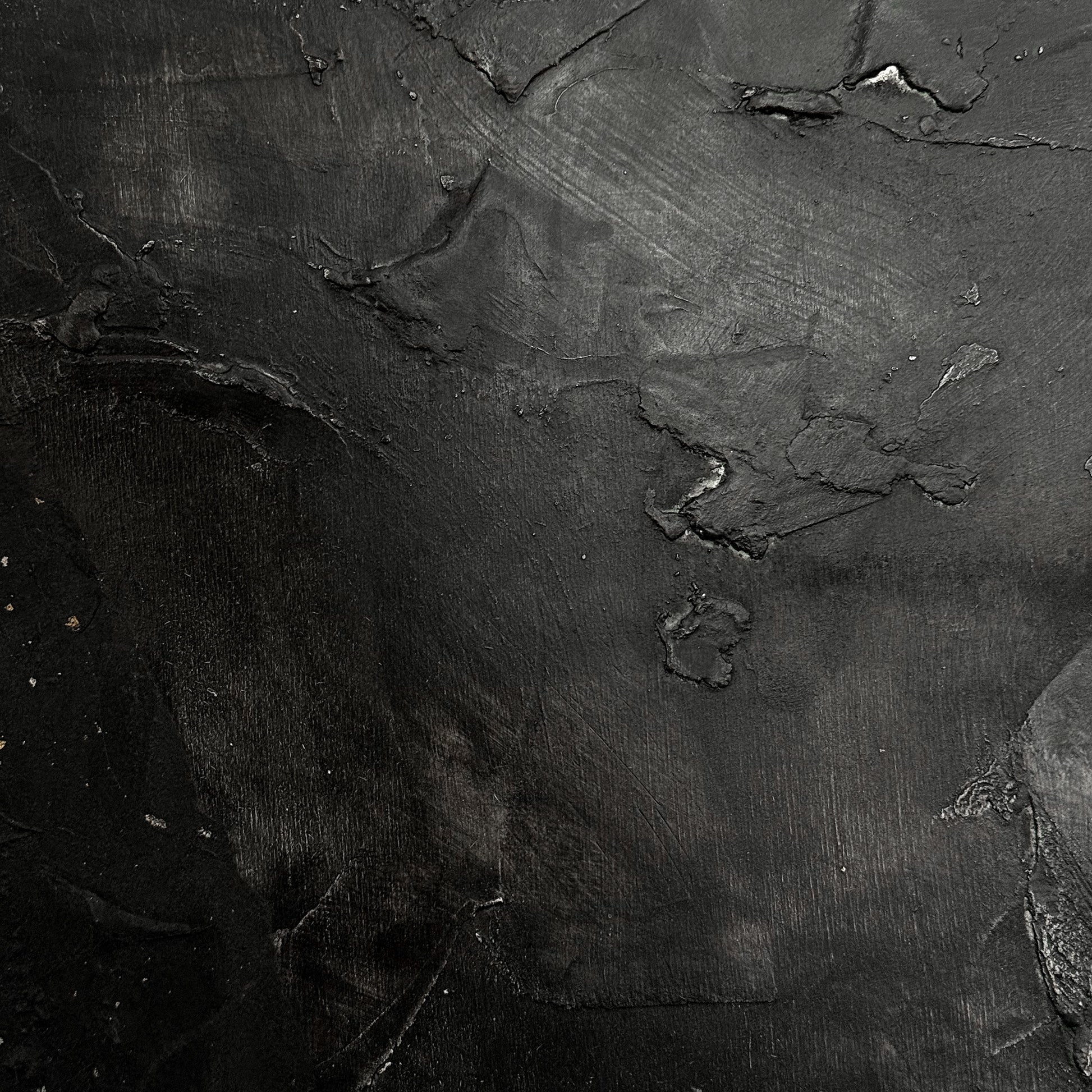 Close-up of dark, textured stone surface