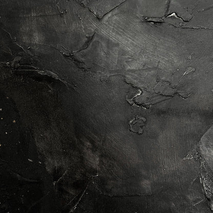 Close-up of dark, textured stone surface