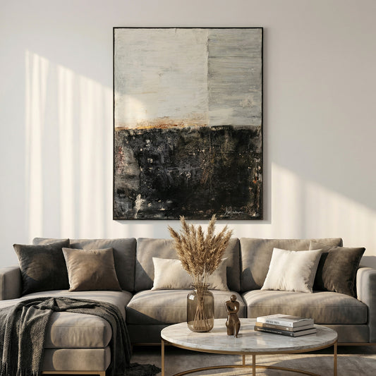 Modern living room with a gray sectional sofa, abstract painting, and decorative items.