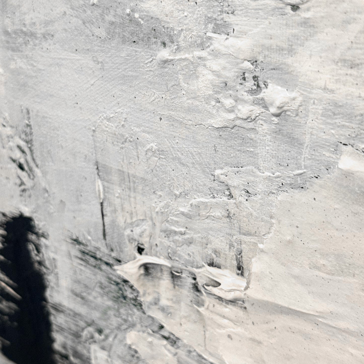Close-up of a textured gray surface with visible brush strokes