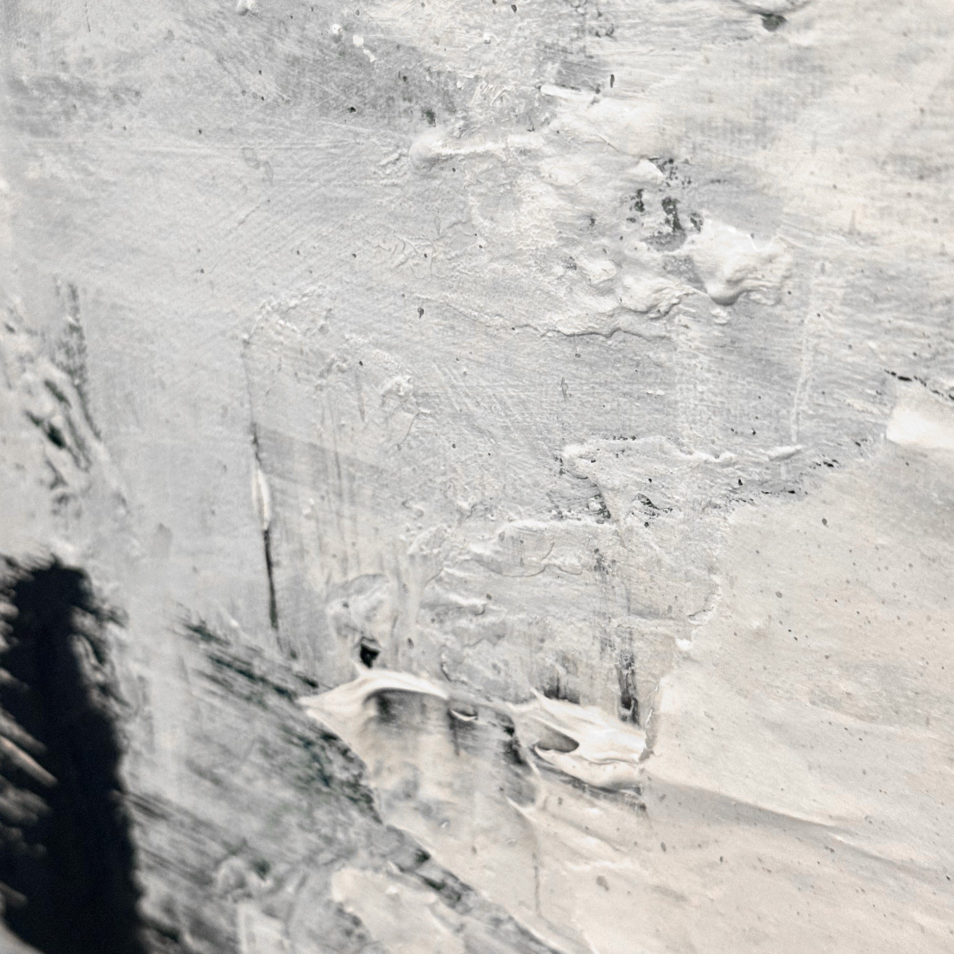 Close-up of a textured gray surface with visible brush strokes